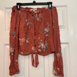 Off the shoulder, long sleeve shirt that stops right at the waist